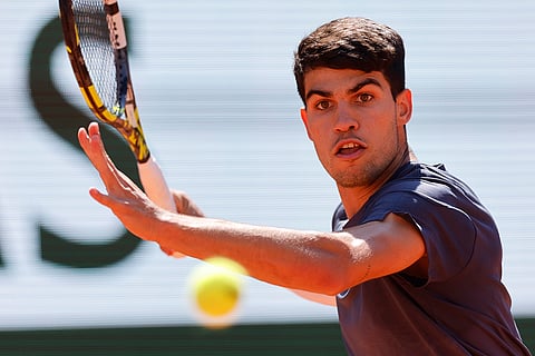 Carlos Alcaraz plays a shot against Jannik Sinner